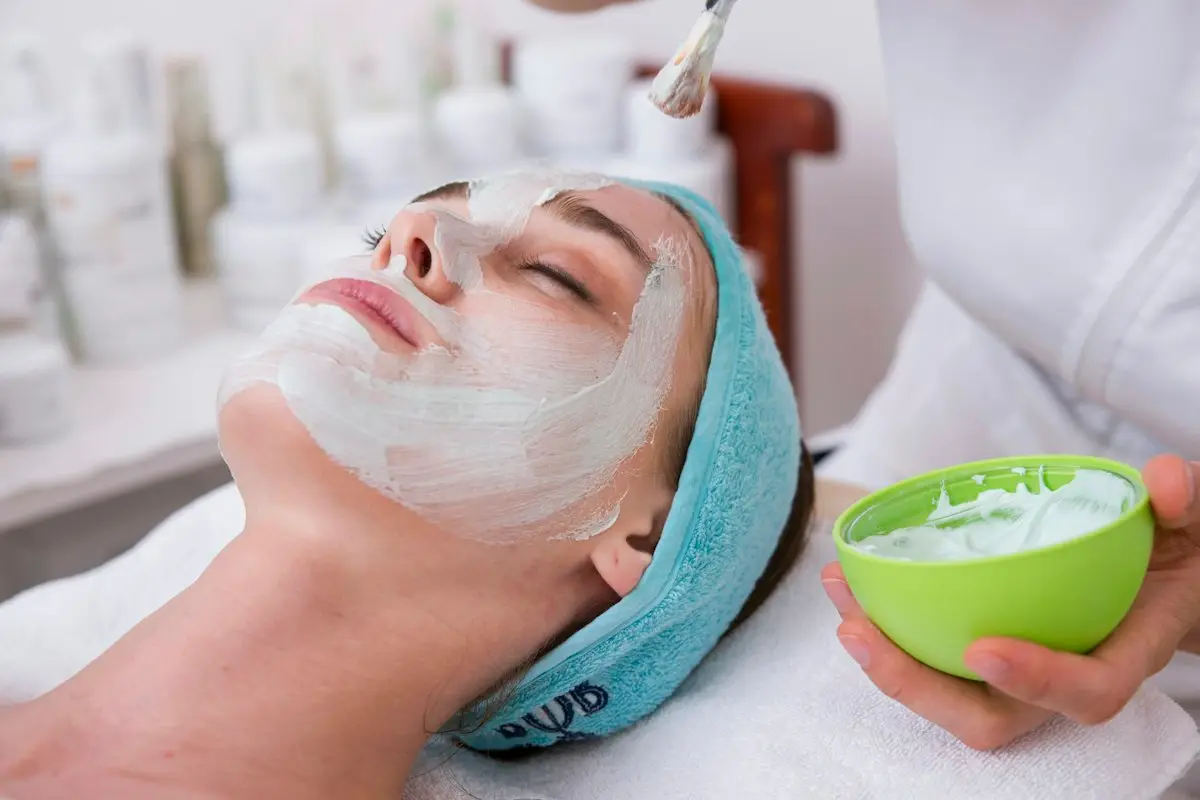 Client relaxing with a cream mask during a facial